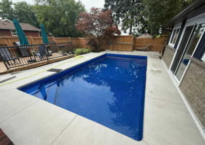 New concrete pool deck installed during backyard pool renovation in Niagara